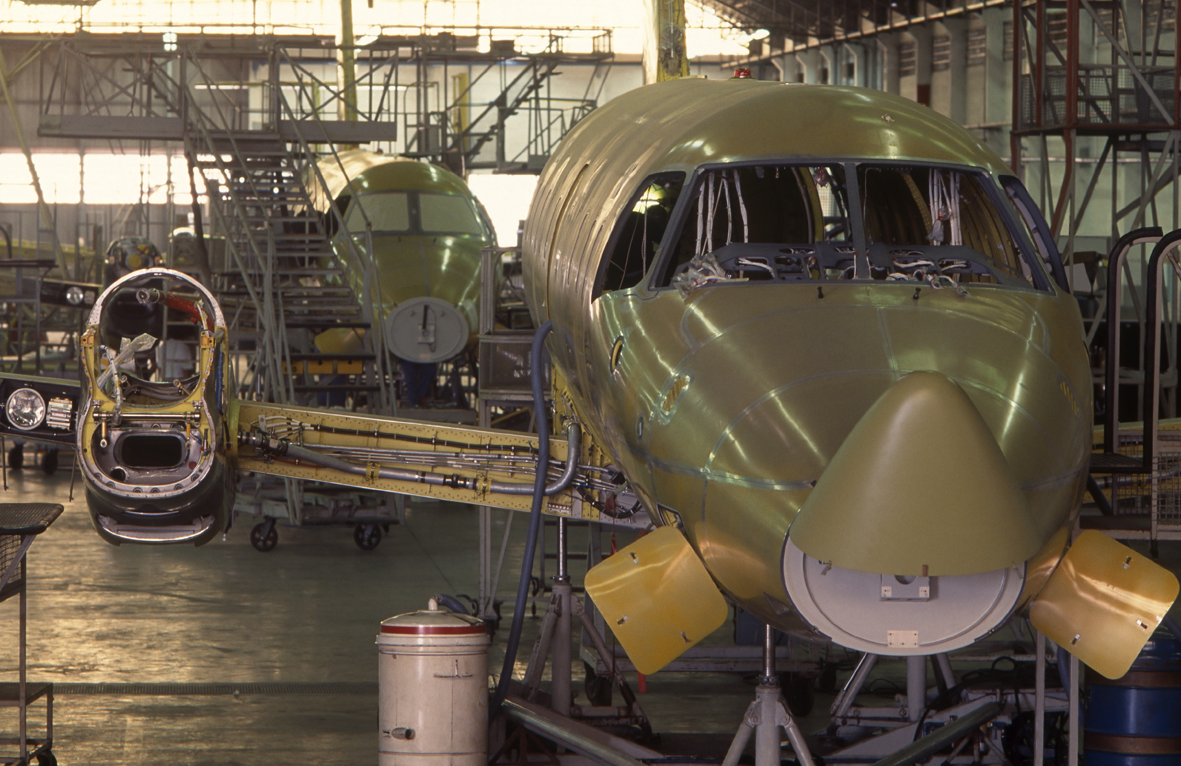 Business jets under construction in an aircraft assembly hangar