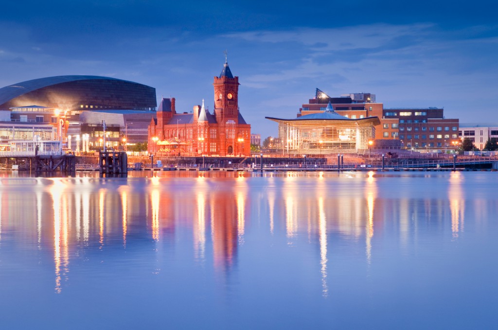 Cardiff Bay waterfront at dusk with the Pierhead Building reflected in the water