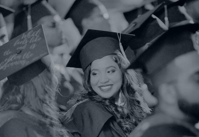 Graduates in caps and gowns at a graduation ceremony