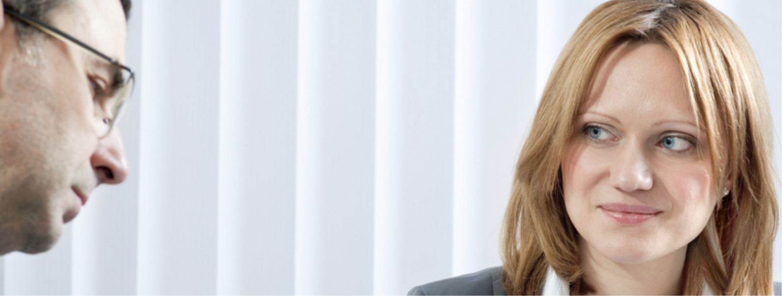 Smiling businesswoman making eye contact in a bright office