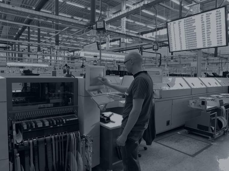 Engineer using a touchscreen control on an automated production line