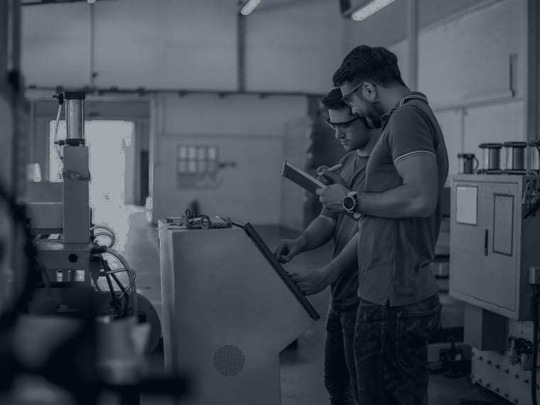 Maintenance technicians working at an industrial machine