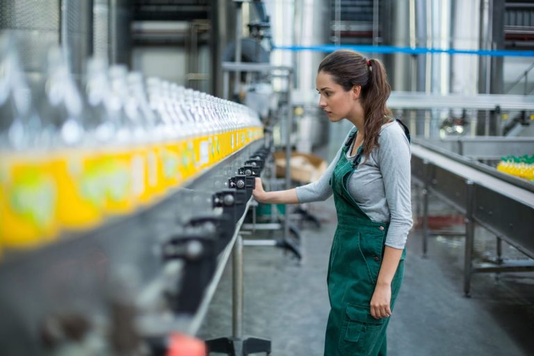 Woman checking quality on a bottling line