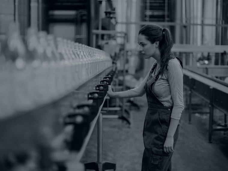 Quality engineer inspecting products on a bottling line